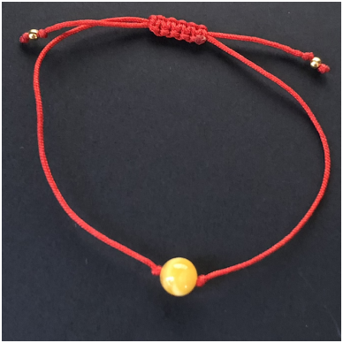 Red string with amber bead